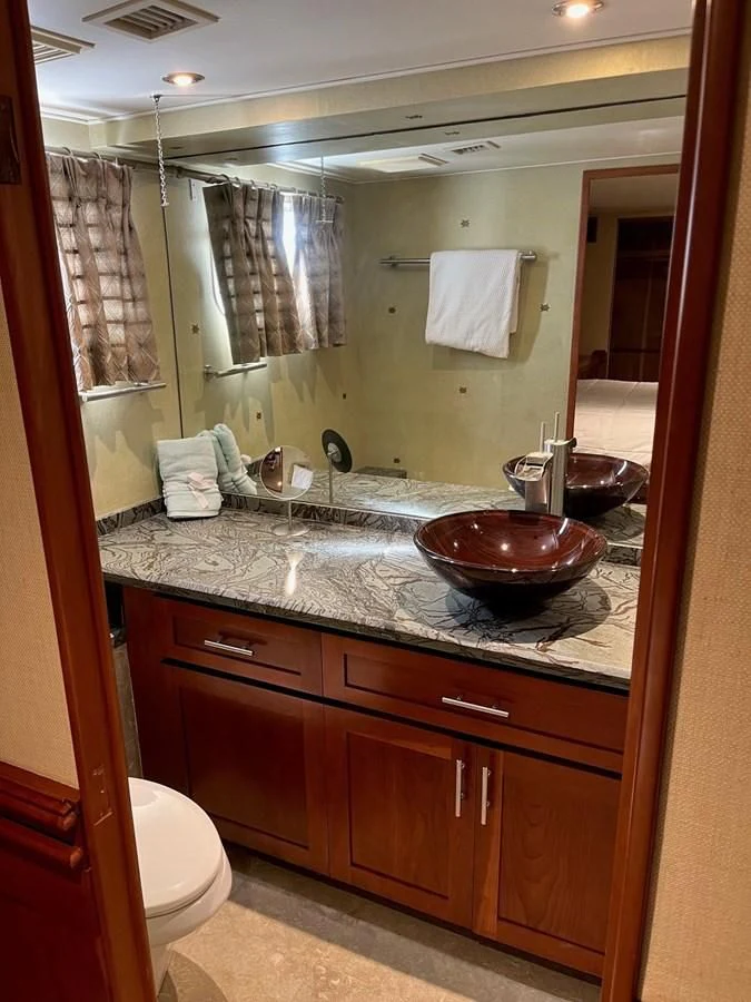 a bathroom with a large mirror aboard SEAQUEST Yacht for Sale