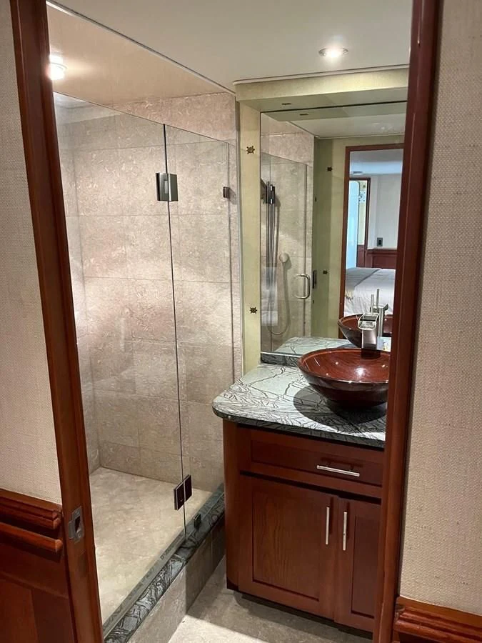 a bathroom with a sink and a mirror aboard SEAQUEST Yacht for Sale