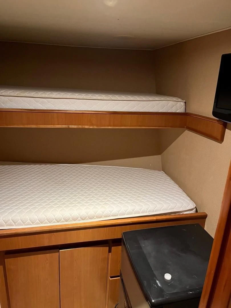 a bed with a white sheet aboard SEAQUEST Yacht for Sale