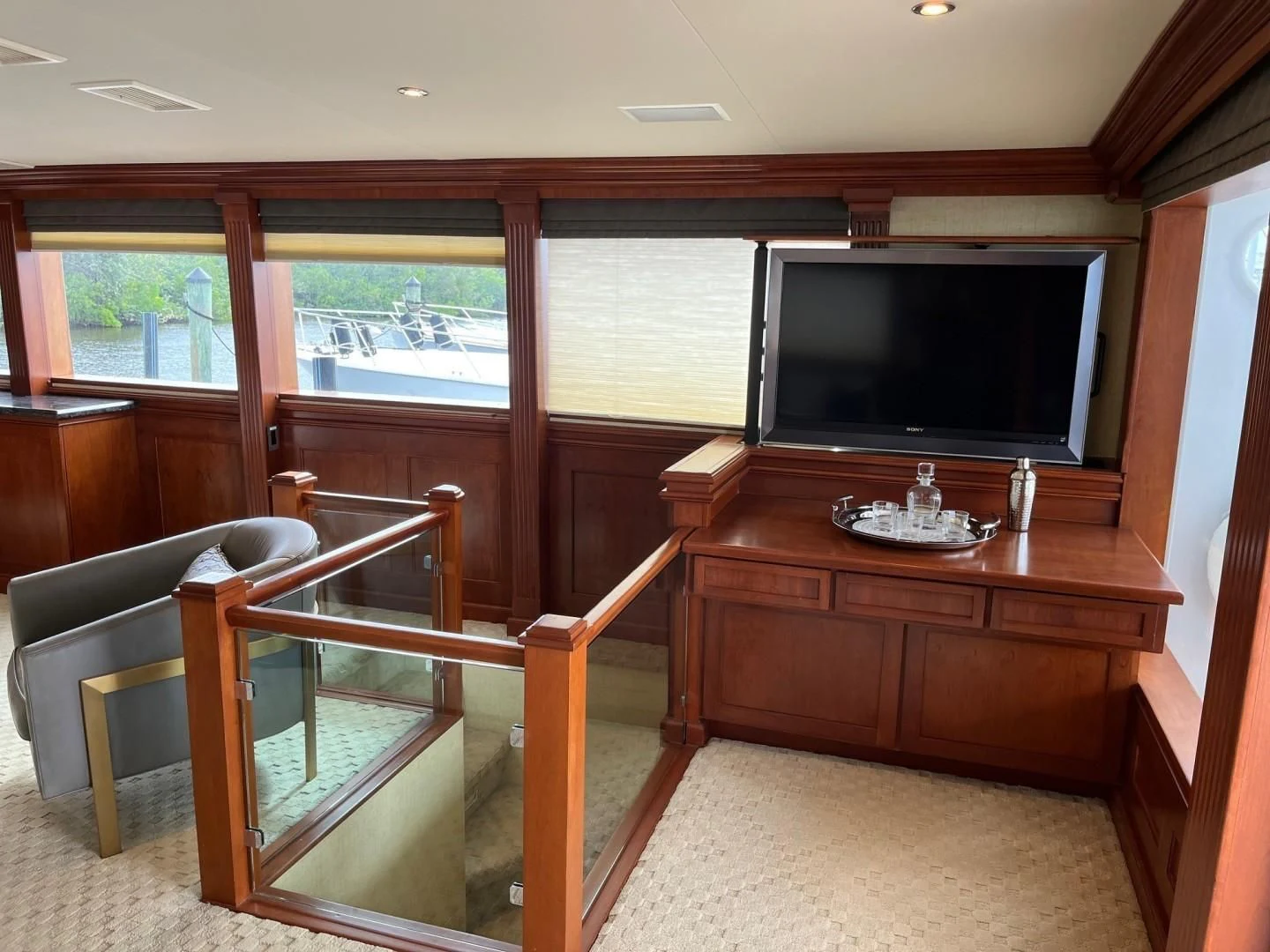 a living room with a tv and furniture aboard SEAQUEST Yacht for Sale