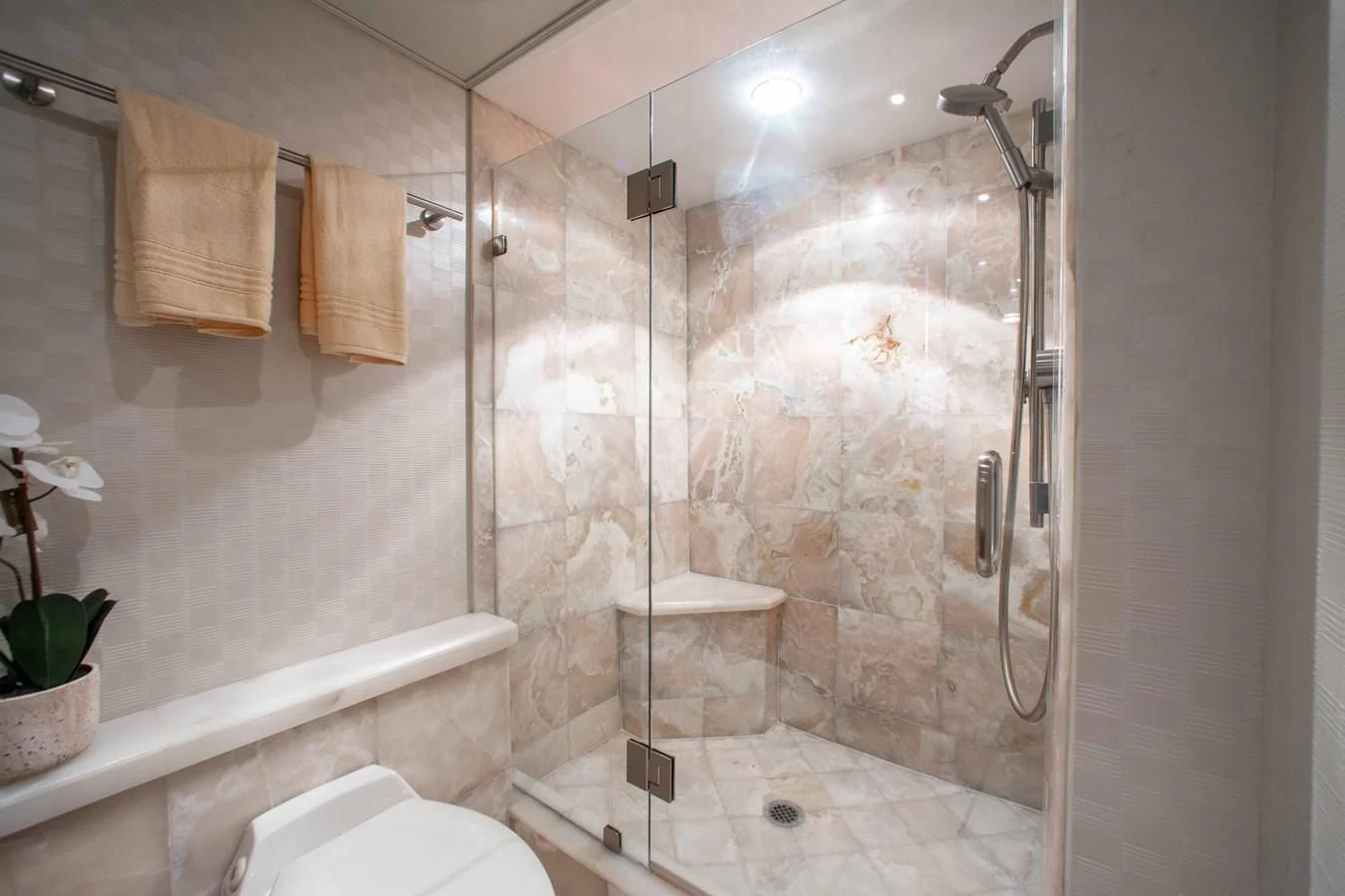 a bathroom with a glass shower aboard SEAQUEST Yacht for Sale
