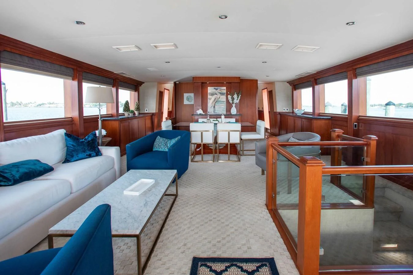 a living room with a blue couch and a table aboard SEAQUEST Yacht for Sale