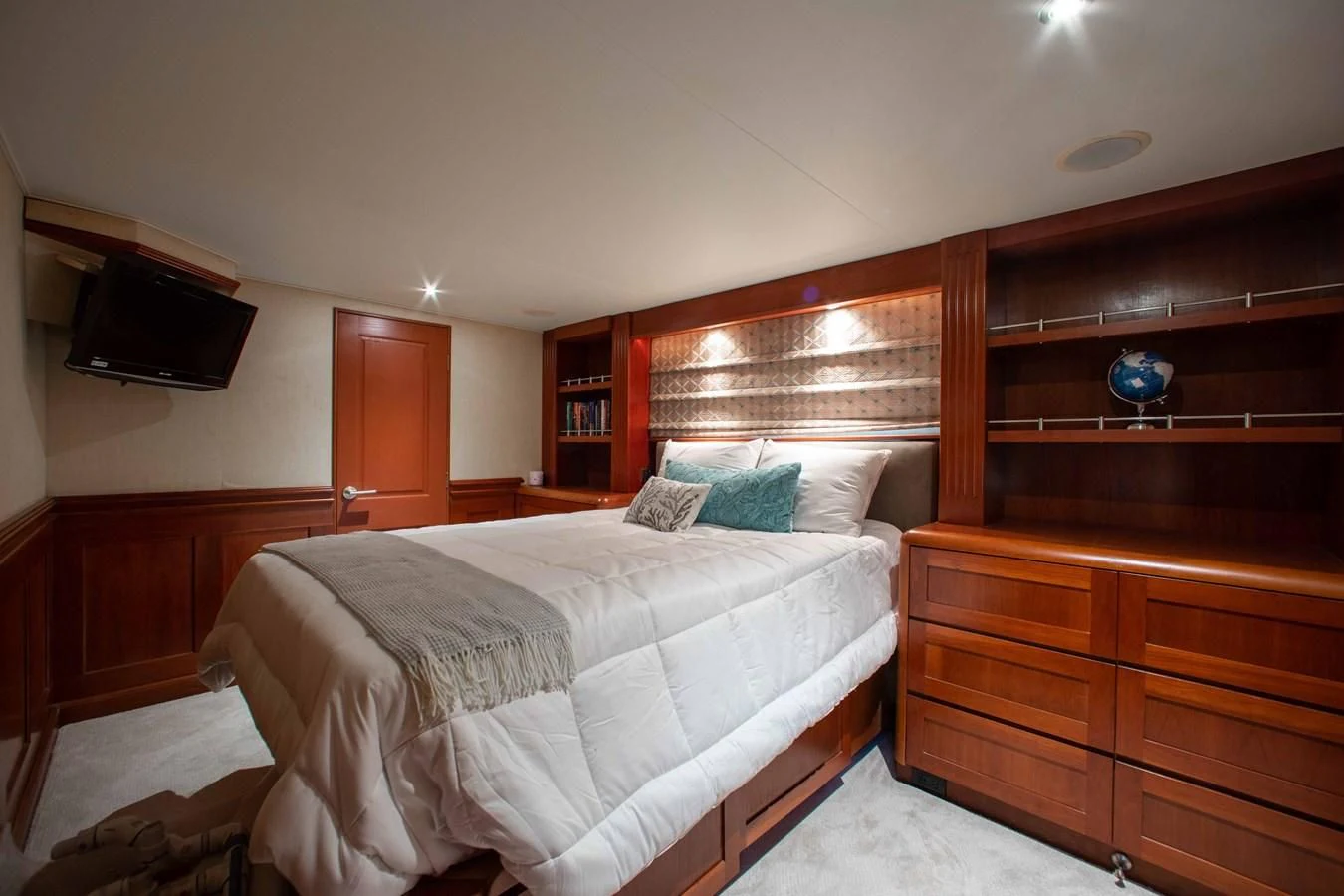 a bedroom with a bed and a television aboard SEAQUEST Yacht for Sale