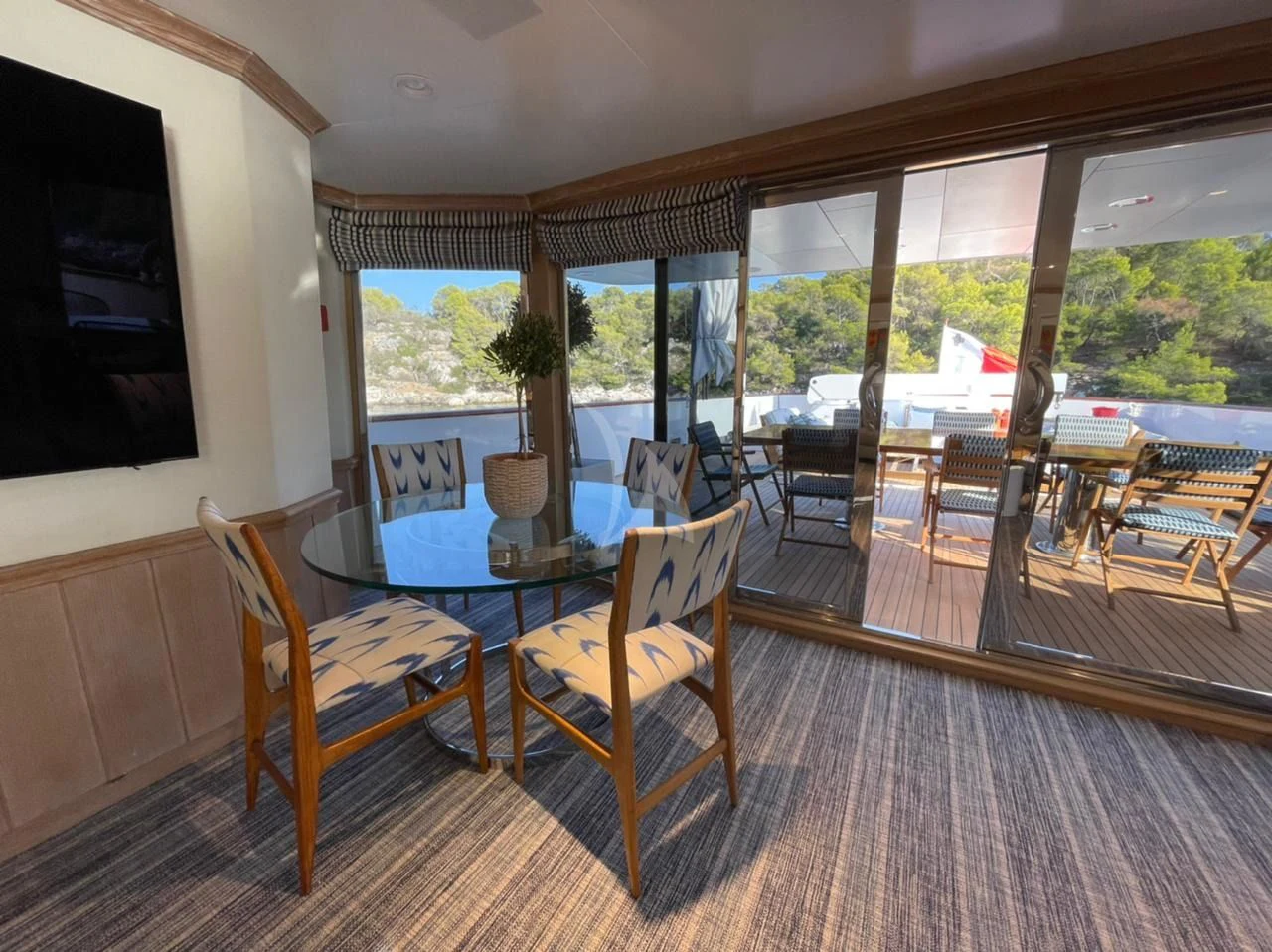 a room with a table and chairs aboard NATALIA V Yacht for Sale