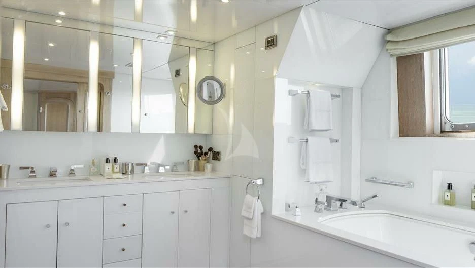 a bathroom with white cabinets aboard NATALIA V Yacht for Sale