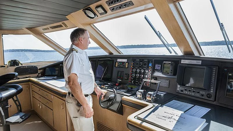 a man standing in front of a desk with a computer and a window aboard NATALIA V Yacht for Sale