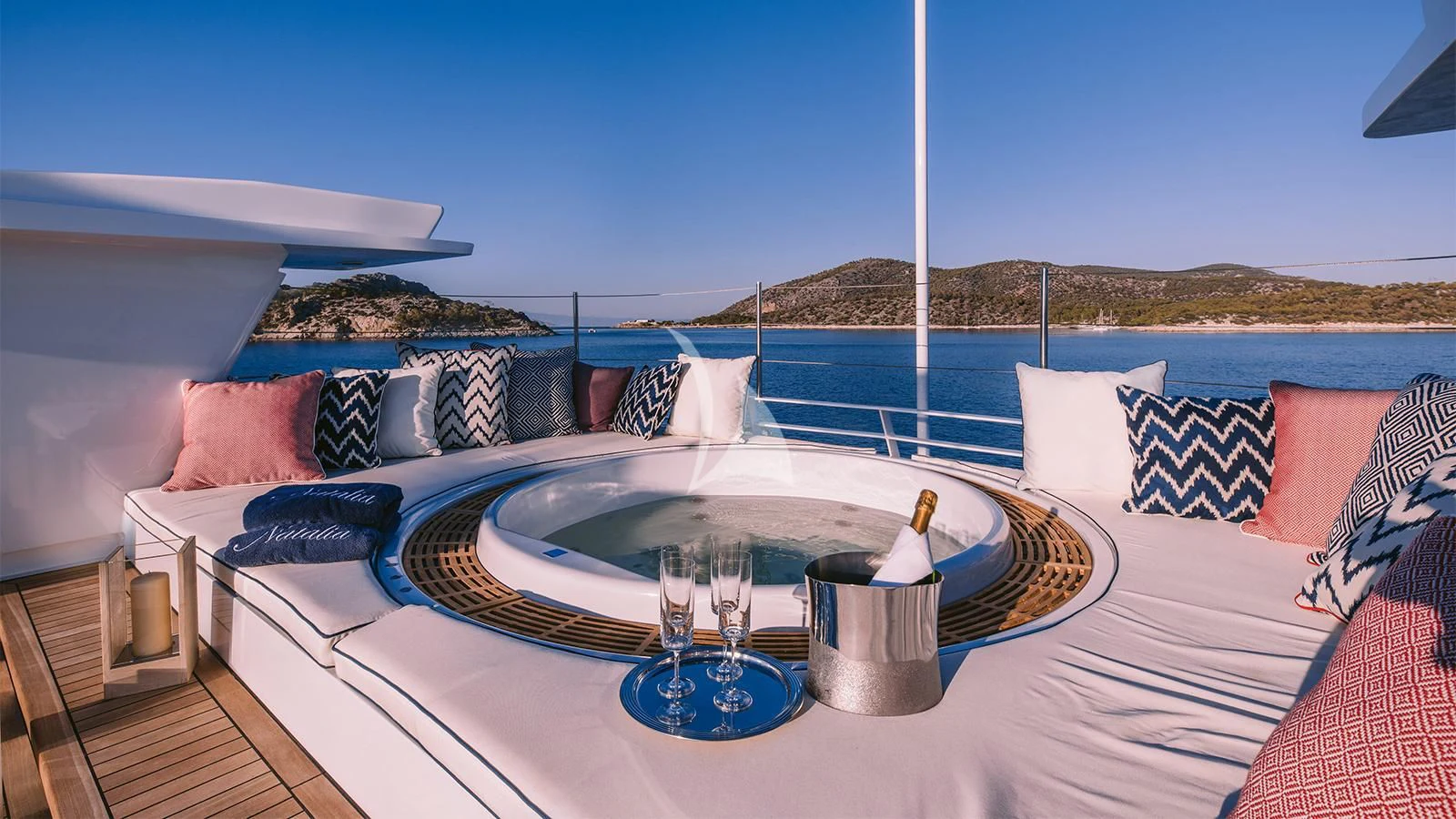 a table with a glass and a tray on it aboard NATALIA V Yacht for Sale