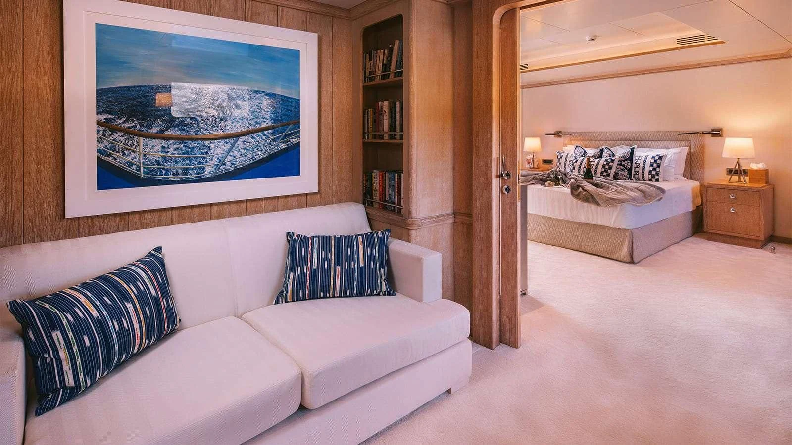 a room with a bed and a painting on the wall aboard NATALIA V Yacht for Sale