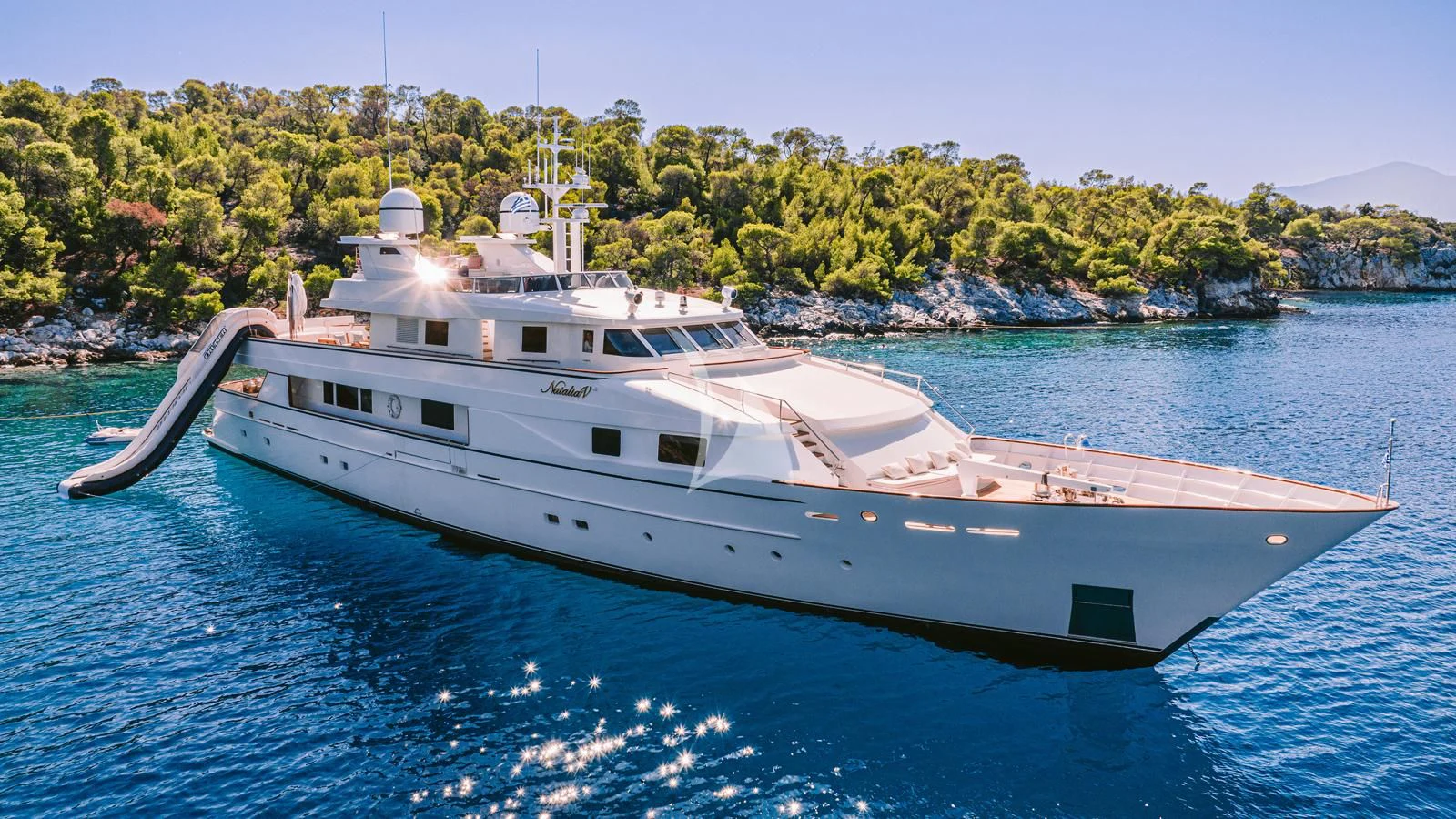 a large white boat in the water aboard NATALIA V Yacht for Sale