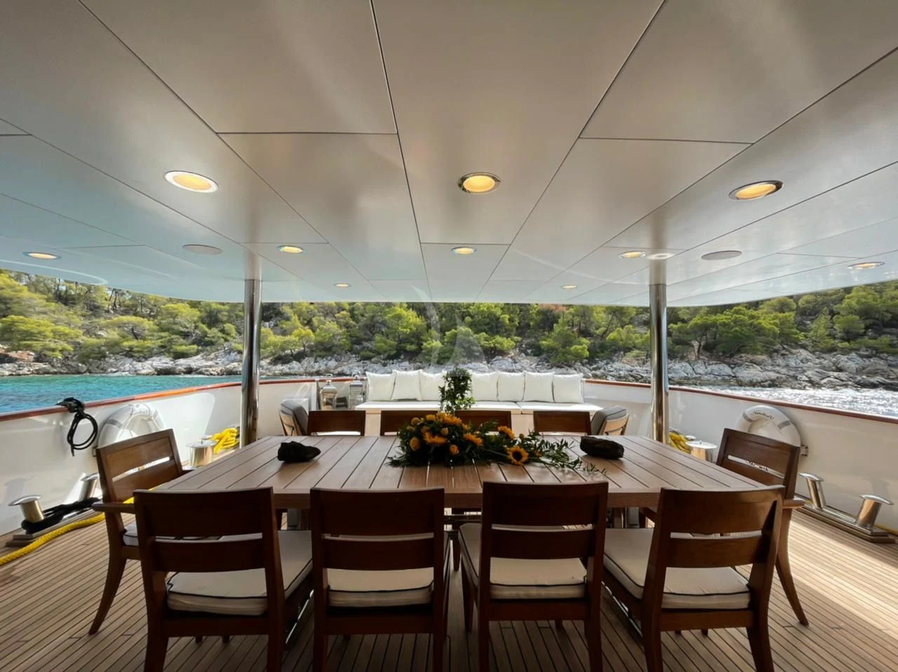 a dining table with chairs and a view of a city aboard NATALIA V Yacht for Sale