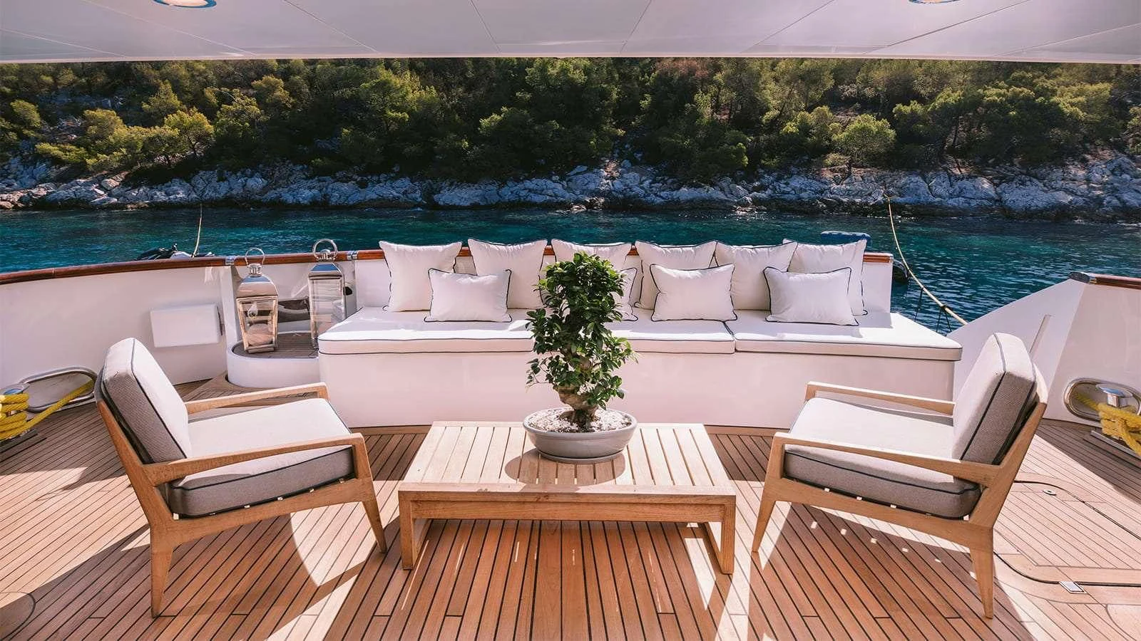 a deck with chairs and a table on it aboard NATALIA V Yacht for Sale