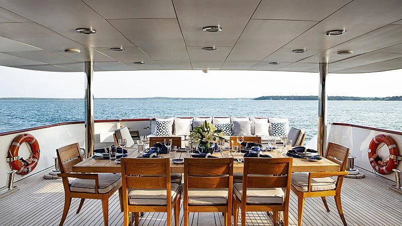 a table with chairs on it aboard NATALIA V Yacht for Sale
