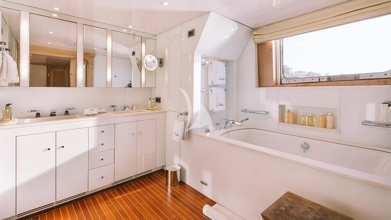 a bathroom with a tub sink and cabinets aboard NATALIA V Yacht for Sale