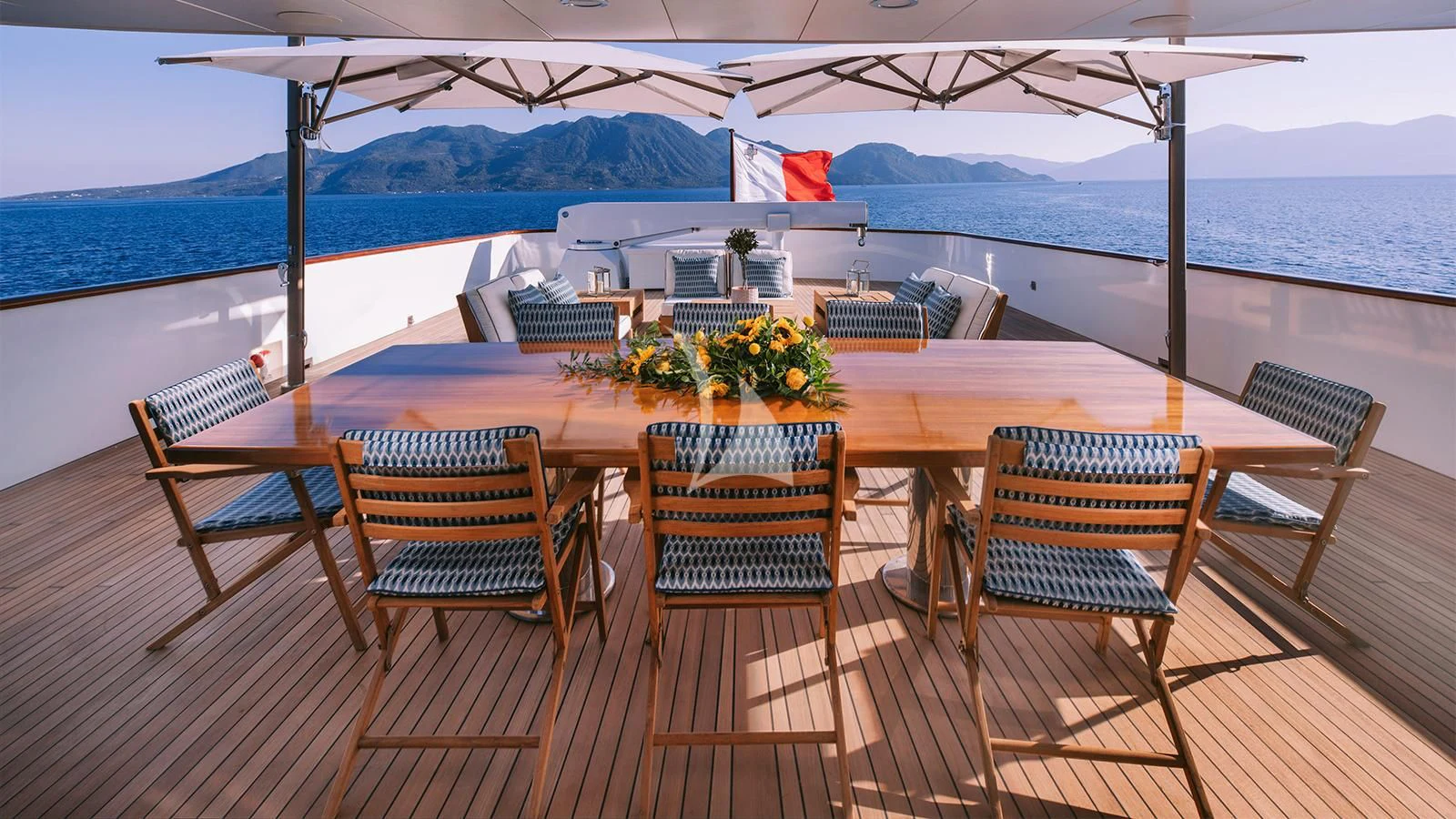 a deck with chairs and a table on it aboard NATALIA V Yacht for Sale