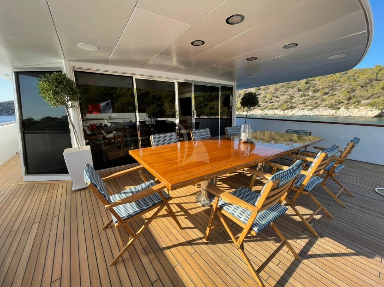 a large room with a table and chairs aboard NATALIA V Yacht for Sale