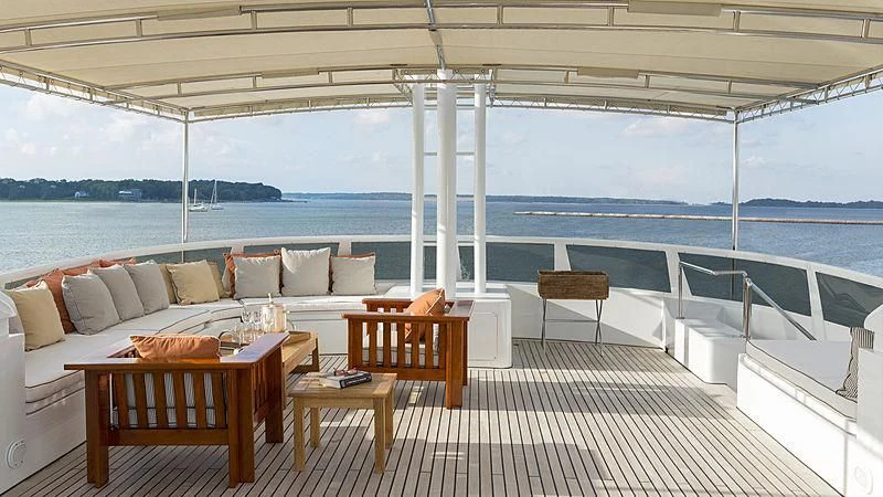 a patio with a couch and a table on it aboard NATALIA V Yacht for Sale