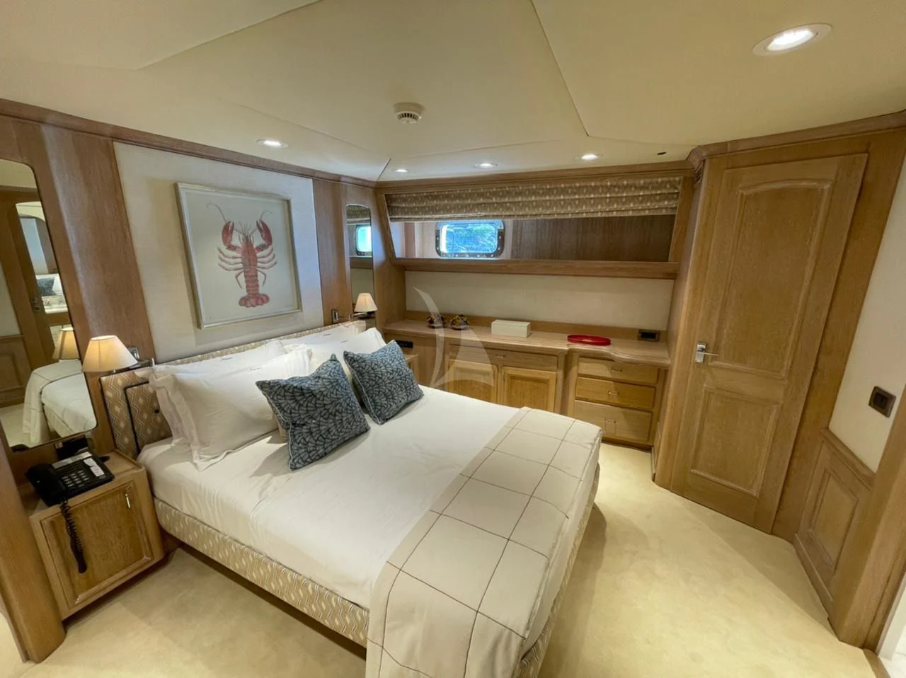 a bedroom with a bed and a desk aboard NATALIA V Yacht for Sale