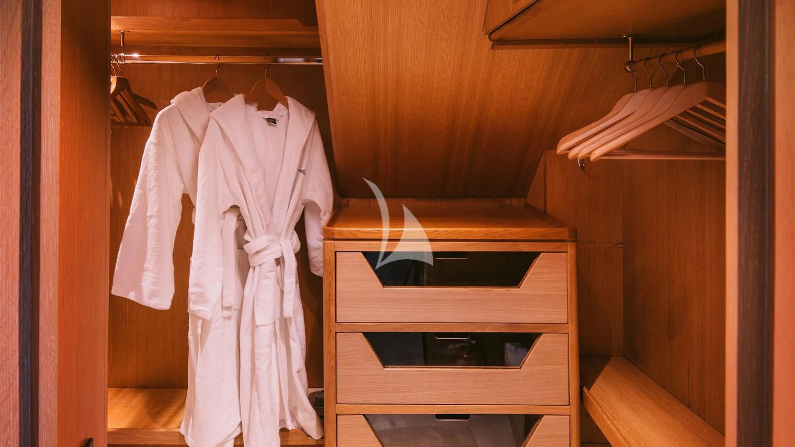 a closet with clothes on the wall aboard NATALIA V Yacht for Sale