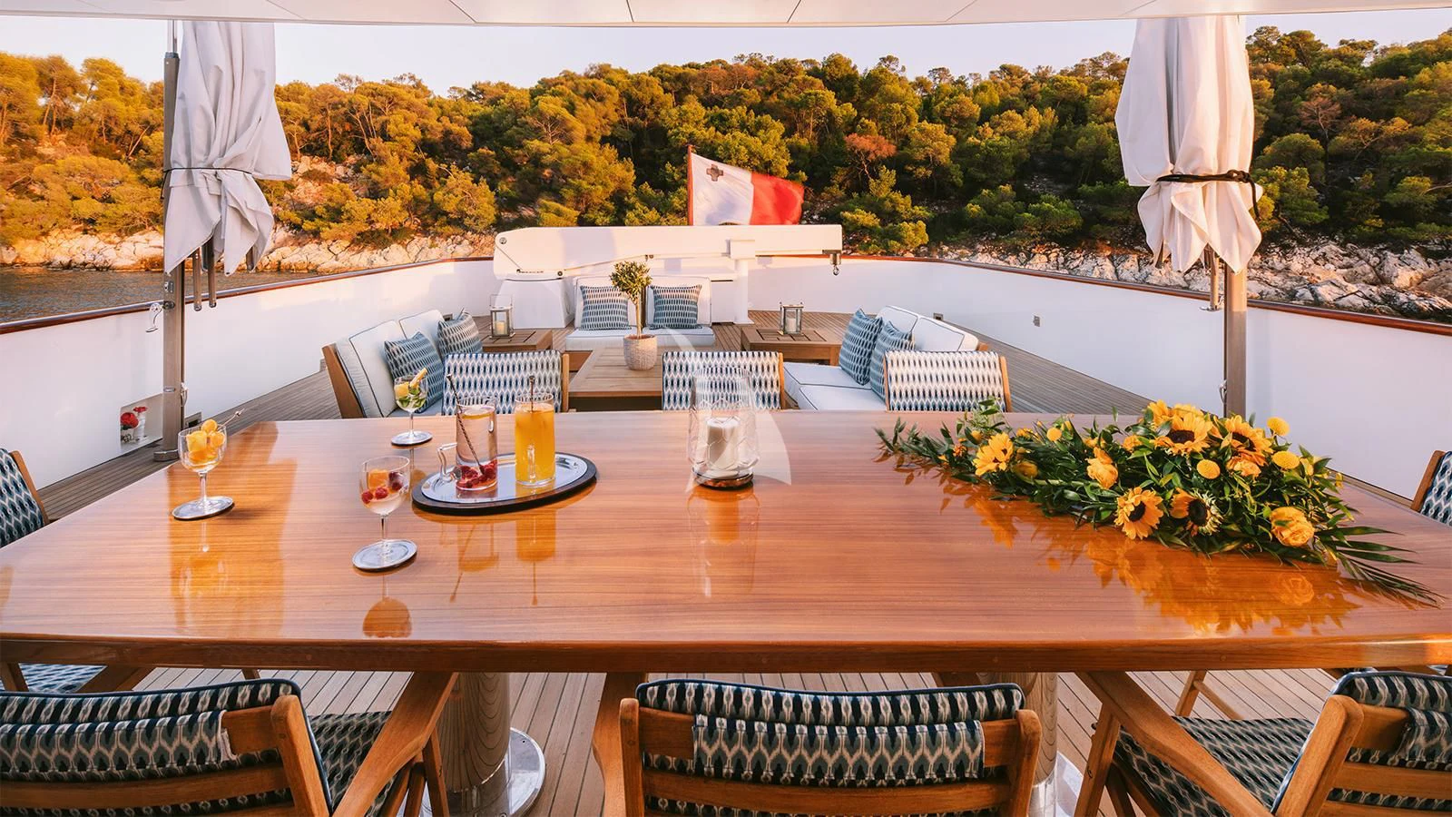 a table with glasses and drinks on it aboard NATALIA V Yacht for Sale