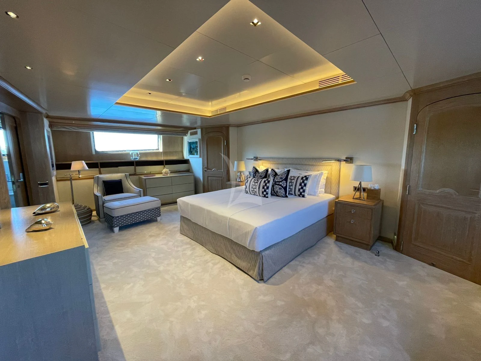 a bedroom with a bed and desk aboard NATALIA V Yacht for Sale
