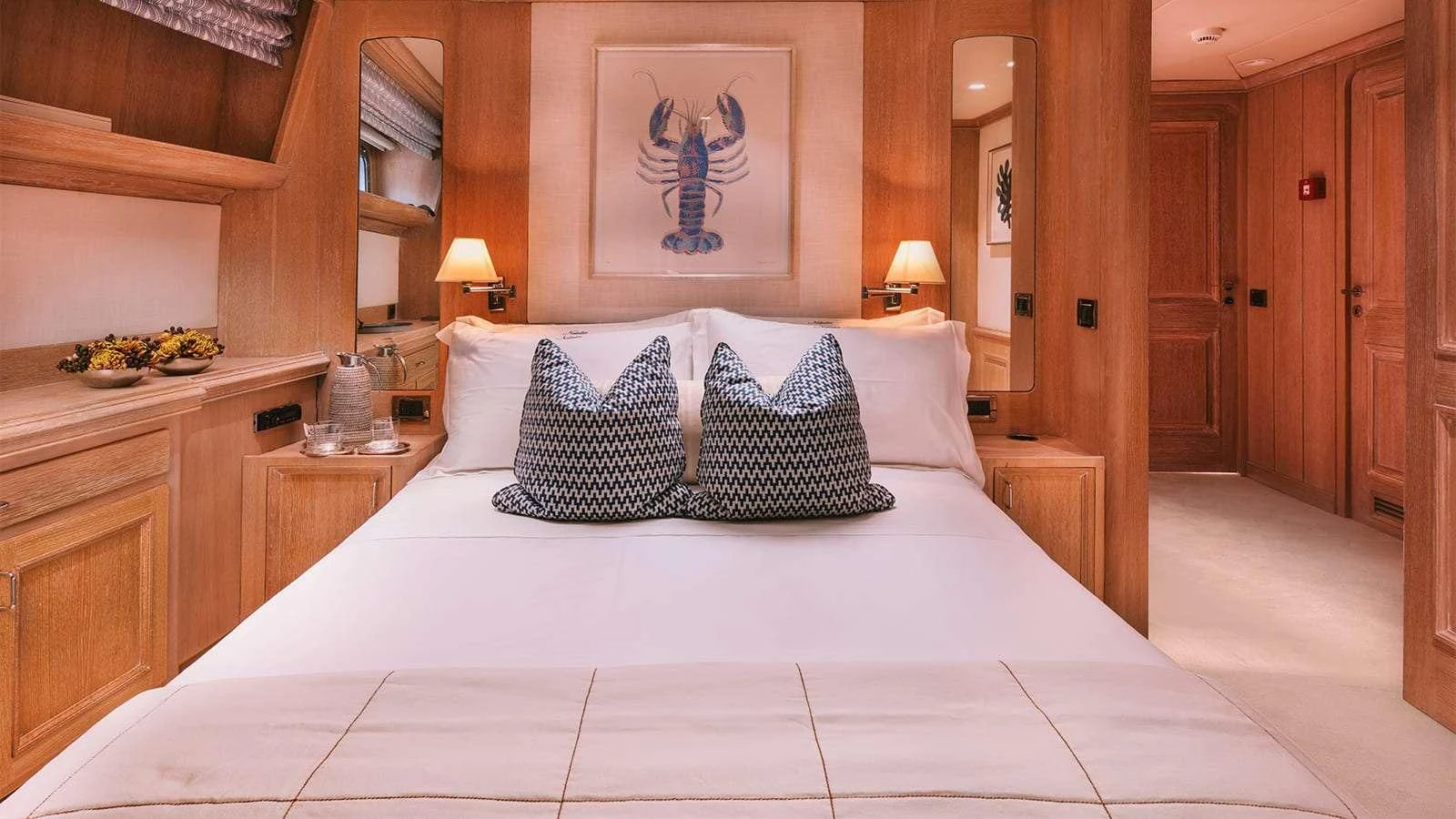 a bed with a white sheet and pillows aboard NATALIA V Yacht for Sale