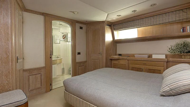 a bedroom with a large bed aboard NATALIA V Yacht for Sale