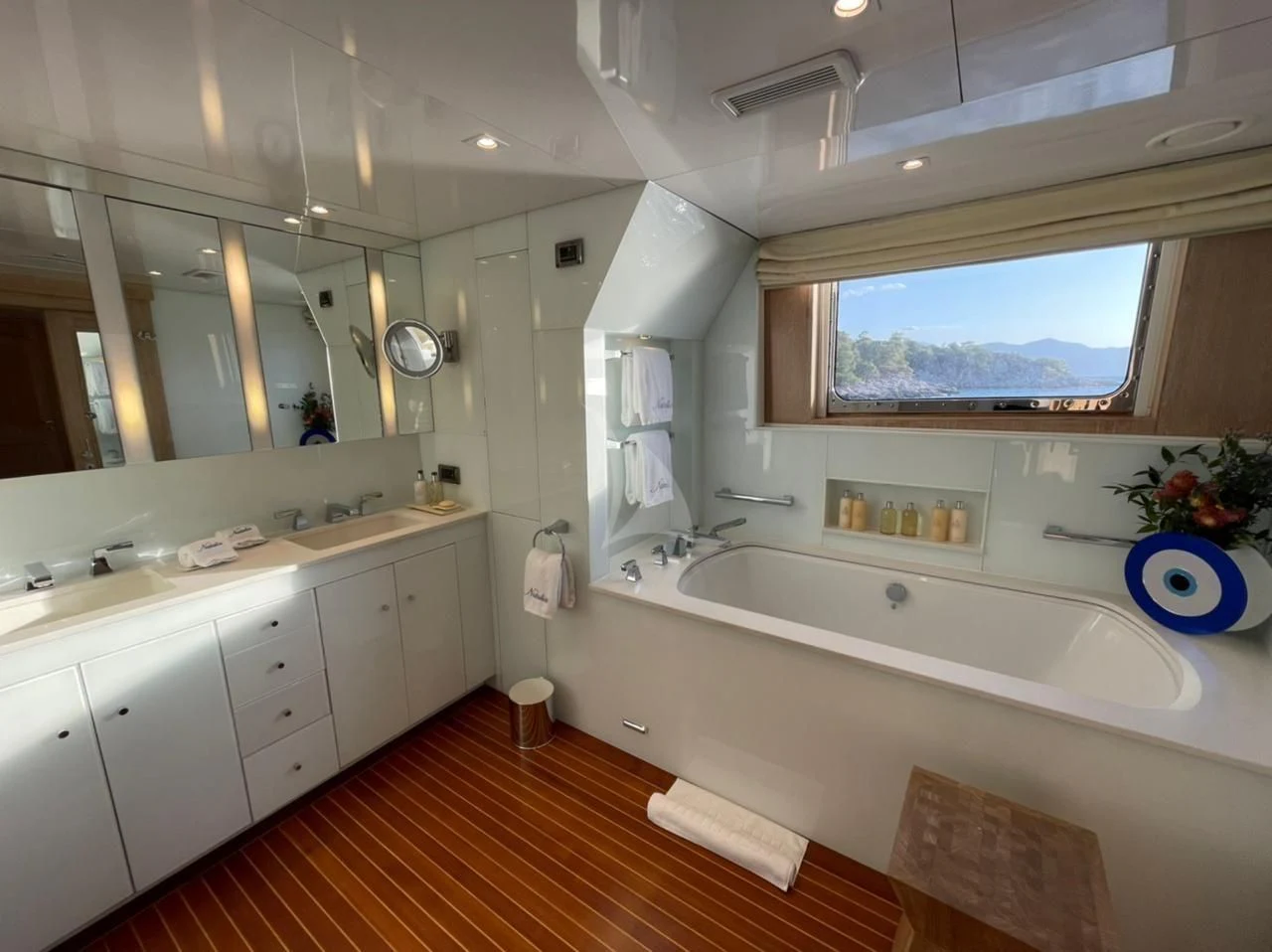 a bathroom with a tub sink and cabinets aboard NATALIA V Yacht for Sale