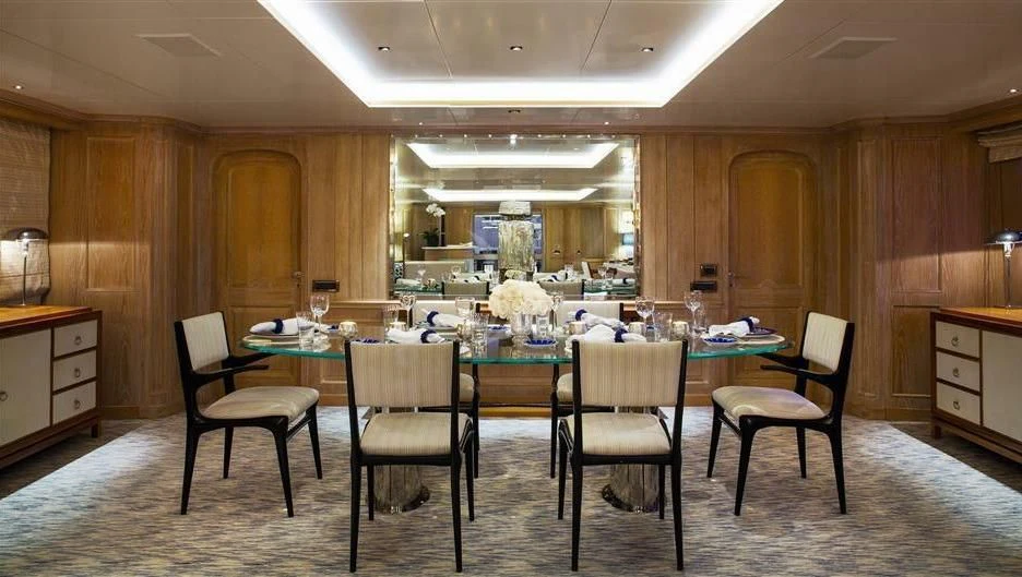 a dining table and chairs in a room aboard NATALIA V Yacht for Sale