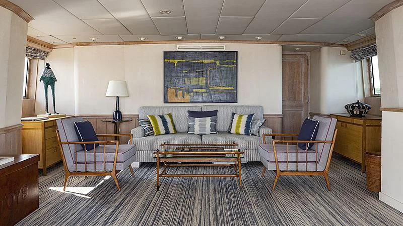 a living room with a couch and chairs aboard NATALIA V Yacht for Sale