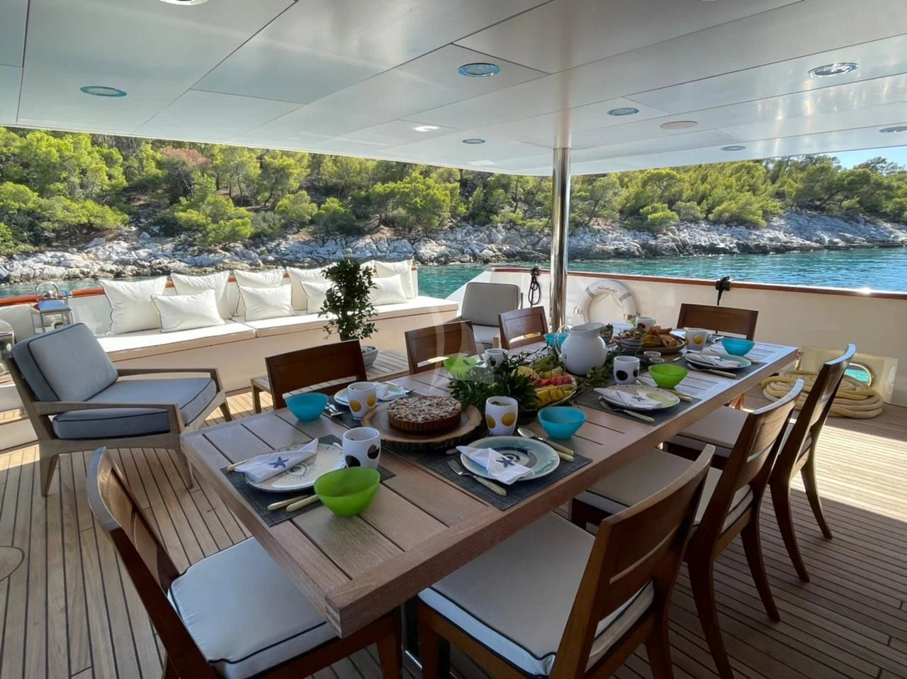 a table with chairs and a couch aboard NATALIA V Yacht for Sale