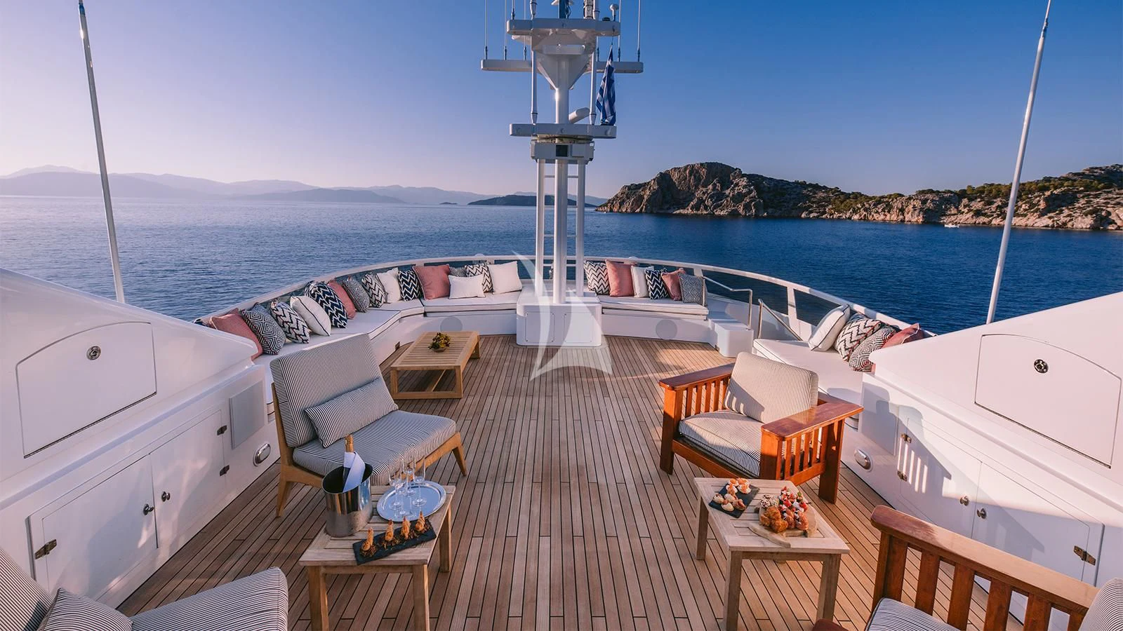 a deck with a view of the ocean and a beach aboard NATALIA V Yacht for Sale