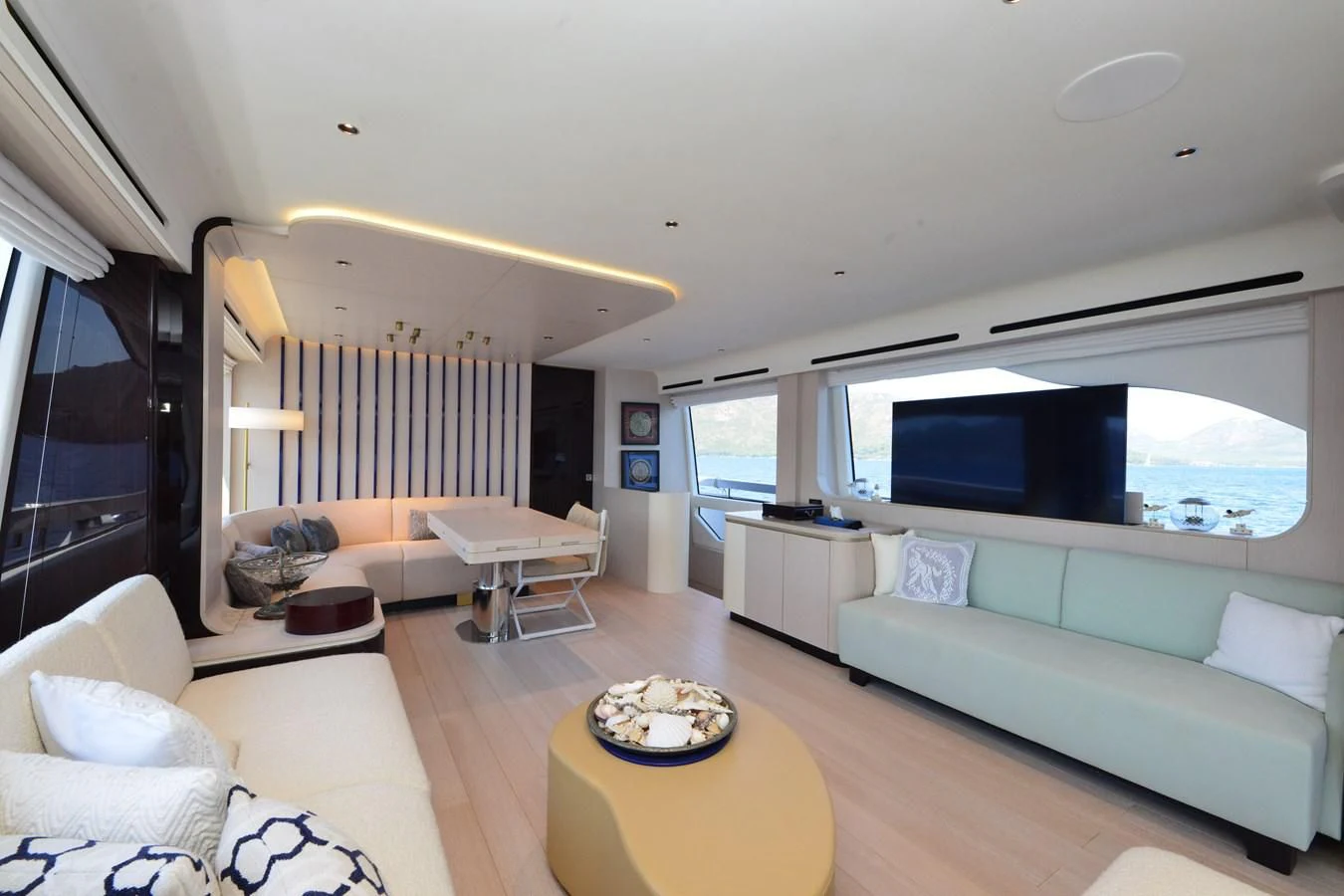 a living room with a large television aboard ANANDA Yacht for Sale