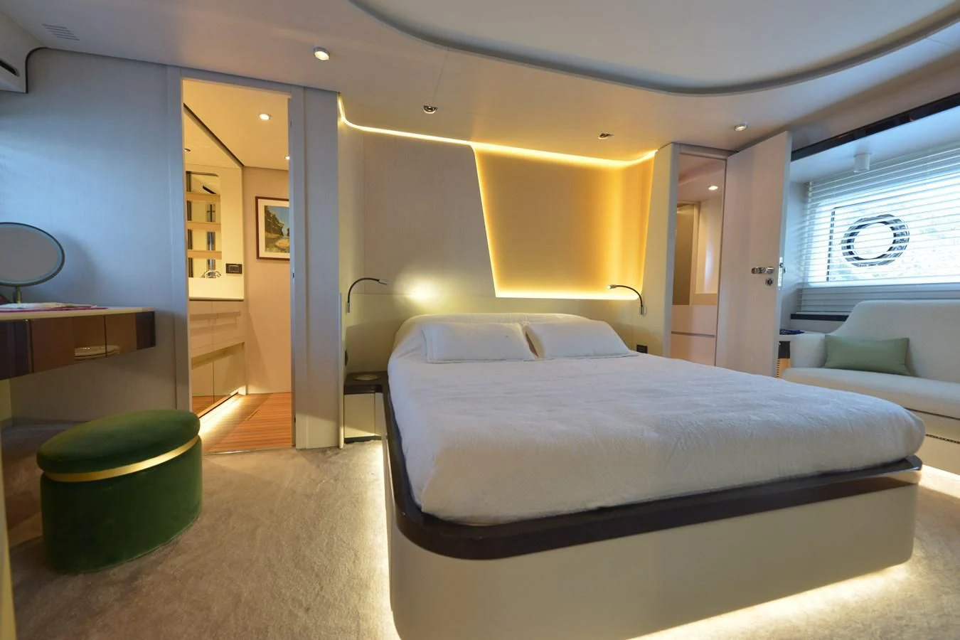 a room with a bed and a couch aboard ANANDA Yacht for Sale