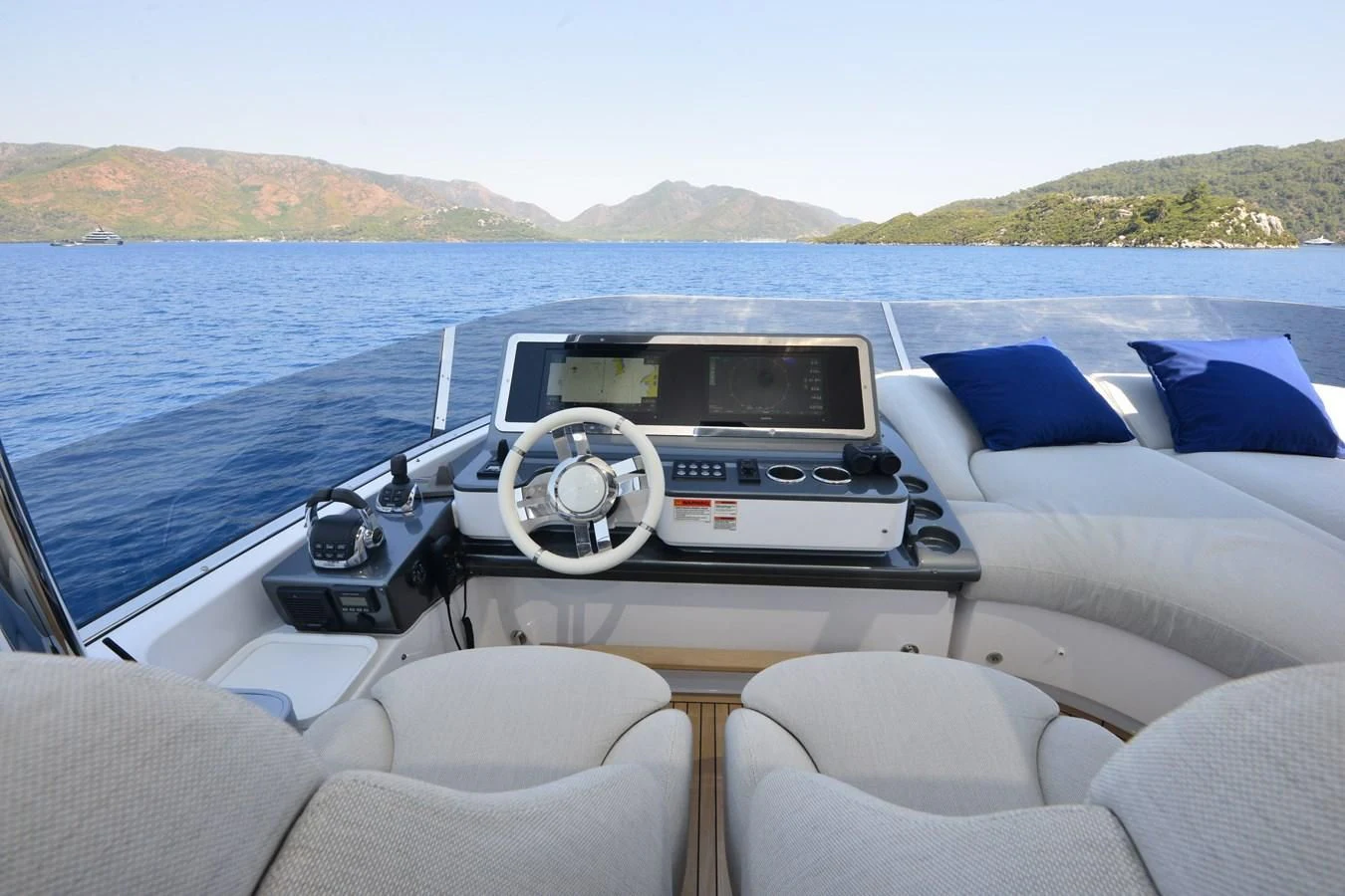 a boat with a steering wheel and a boat in the water aboard ANANDA Yacht for Sale