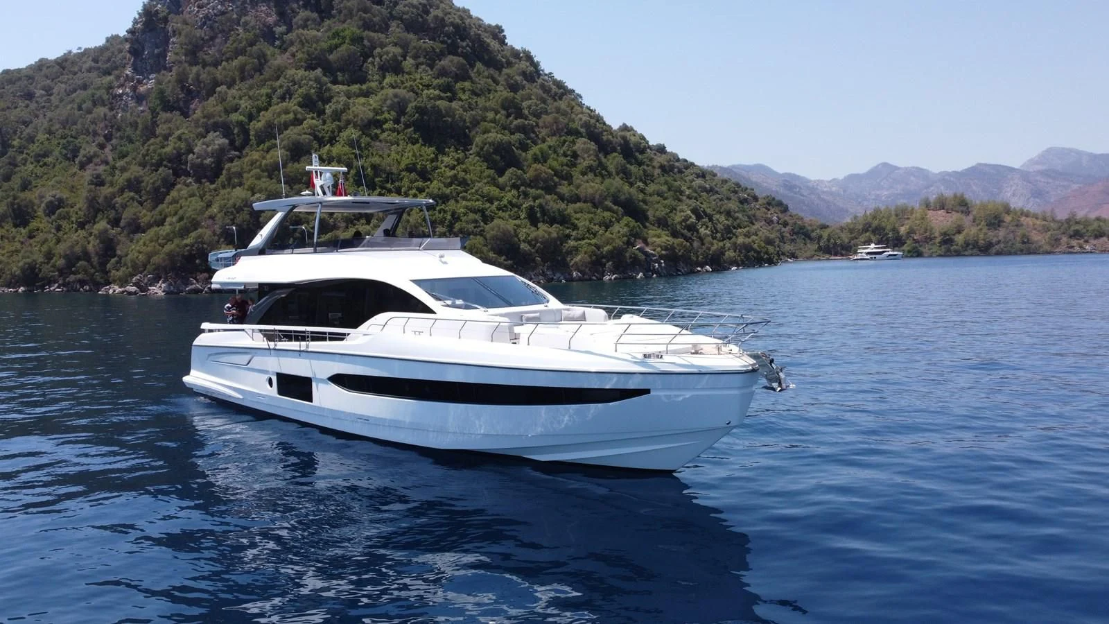 a white yacht on the water aboard ANANDA Yacht for Sale