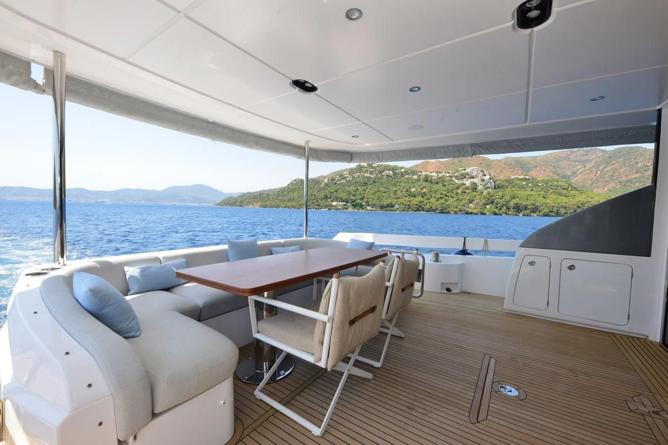 a room with a table and chairs aboard ANANDA Yacht for Sale