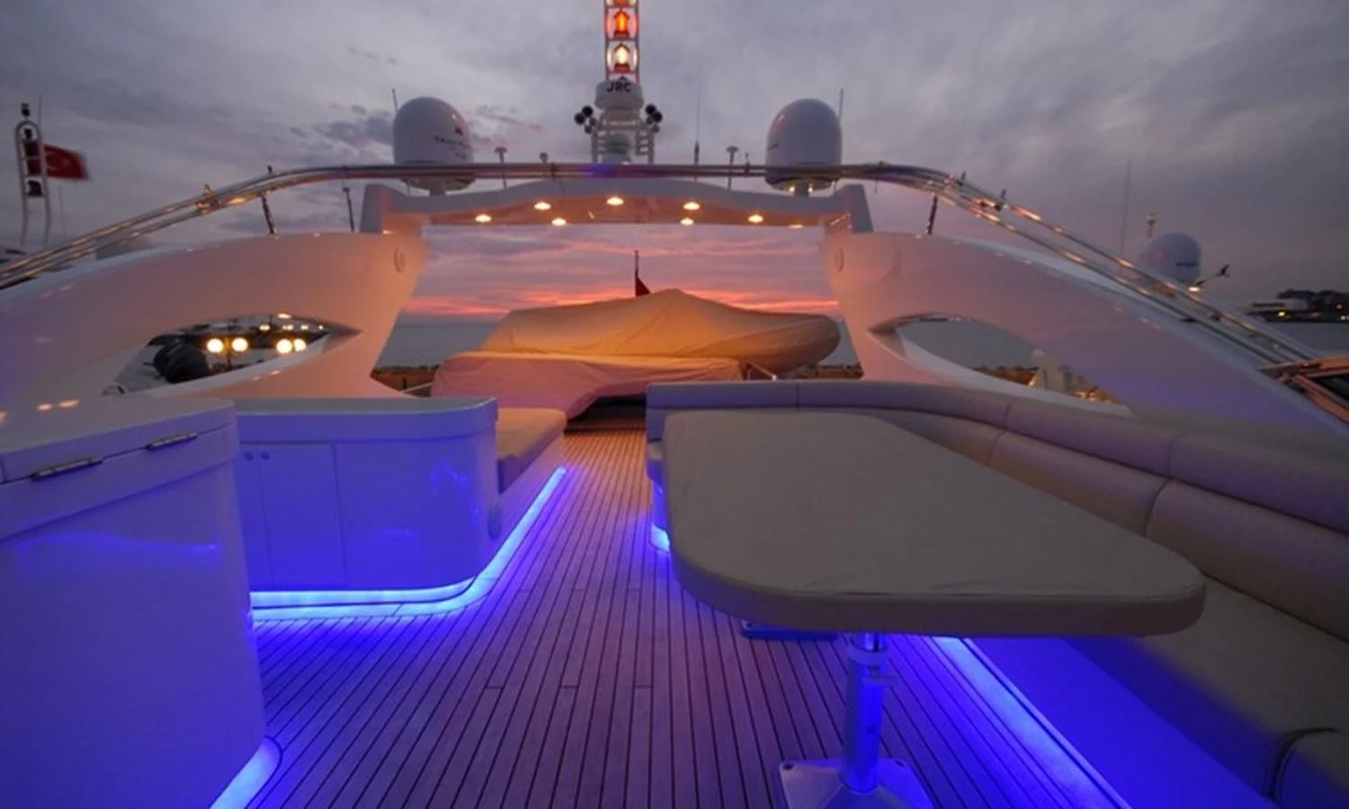 a boat with lights on the water aboard CORAL Yacht for Sale
