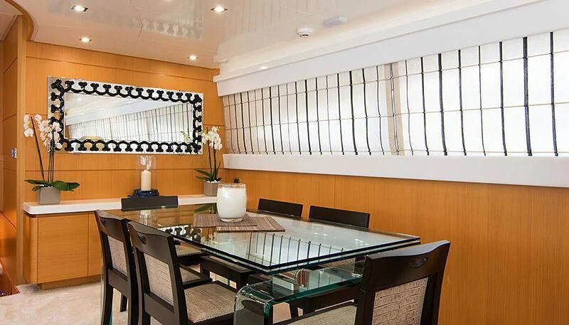 a room with a table and chairs aboard HABANO Yacht for Sale