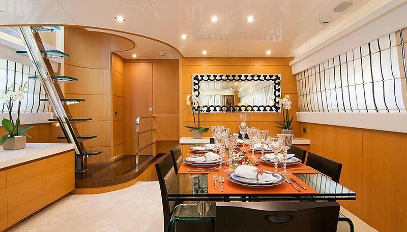 a dining room with a table and chairs aboard HABANO Yacht for Sale