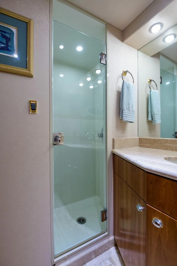 a bathroom with a glass shower door aboard MY GIRL Yacht for Sale