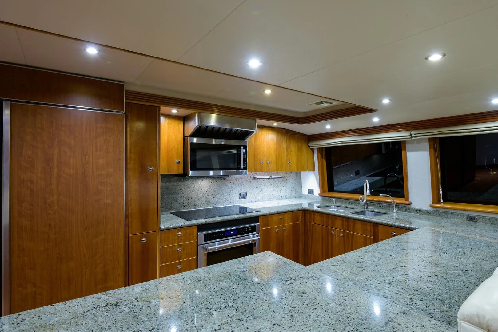 a kitchen with wooden cabinets aboard MY GIRL Yacht for Sale