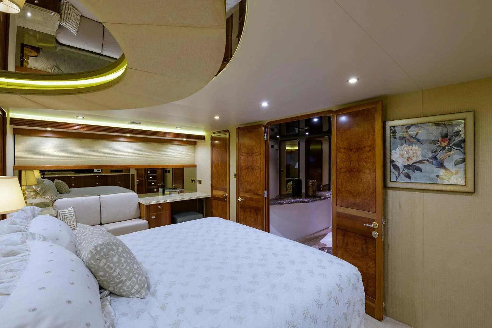 a bedroom with a bed and a wood door aboard MY GIRL Yacht for Sale
