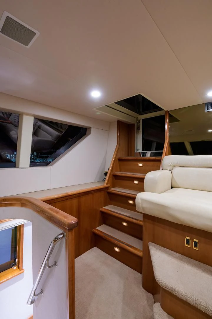 a room with a bed and a television on the wall aboard MY GIRL Yacht for Sale