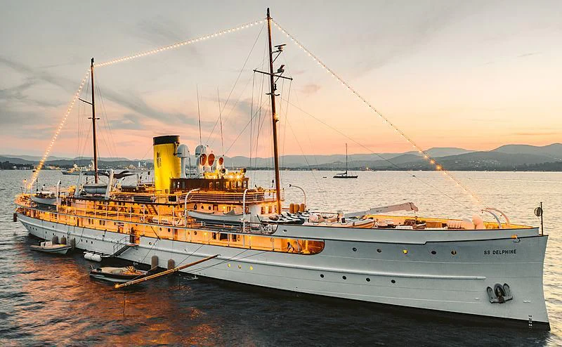 a large white boat with a yellow crane on it aboard SS DELPHINE Yacht for Sale