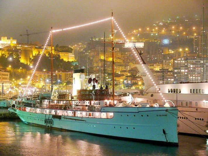 a couple of boats sit in a harbor aboard SS DELPHINE Yacht for Sale