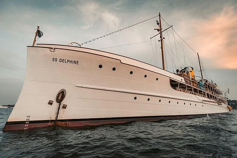 a large white boat with people on it aboard SS DELPHINE Yacht for Sale
