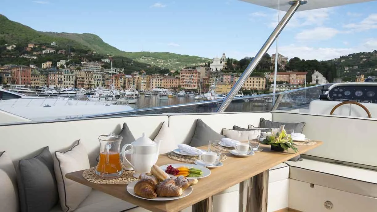 a table with food and drinks on it aboard LUMINOUS Yacht for Sale