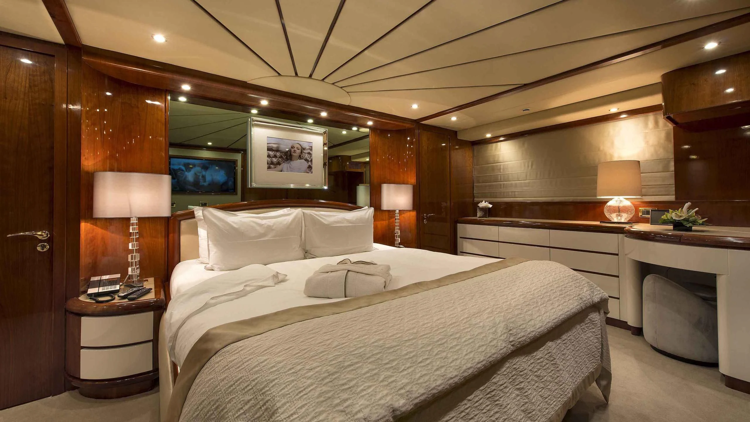 a large bedroom with a large bed aboard LUMINOUS Yacht for Sale
