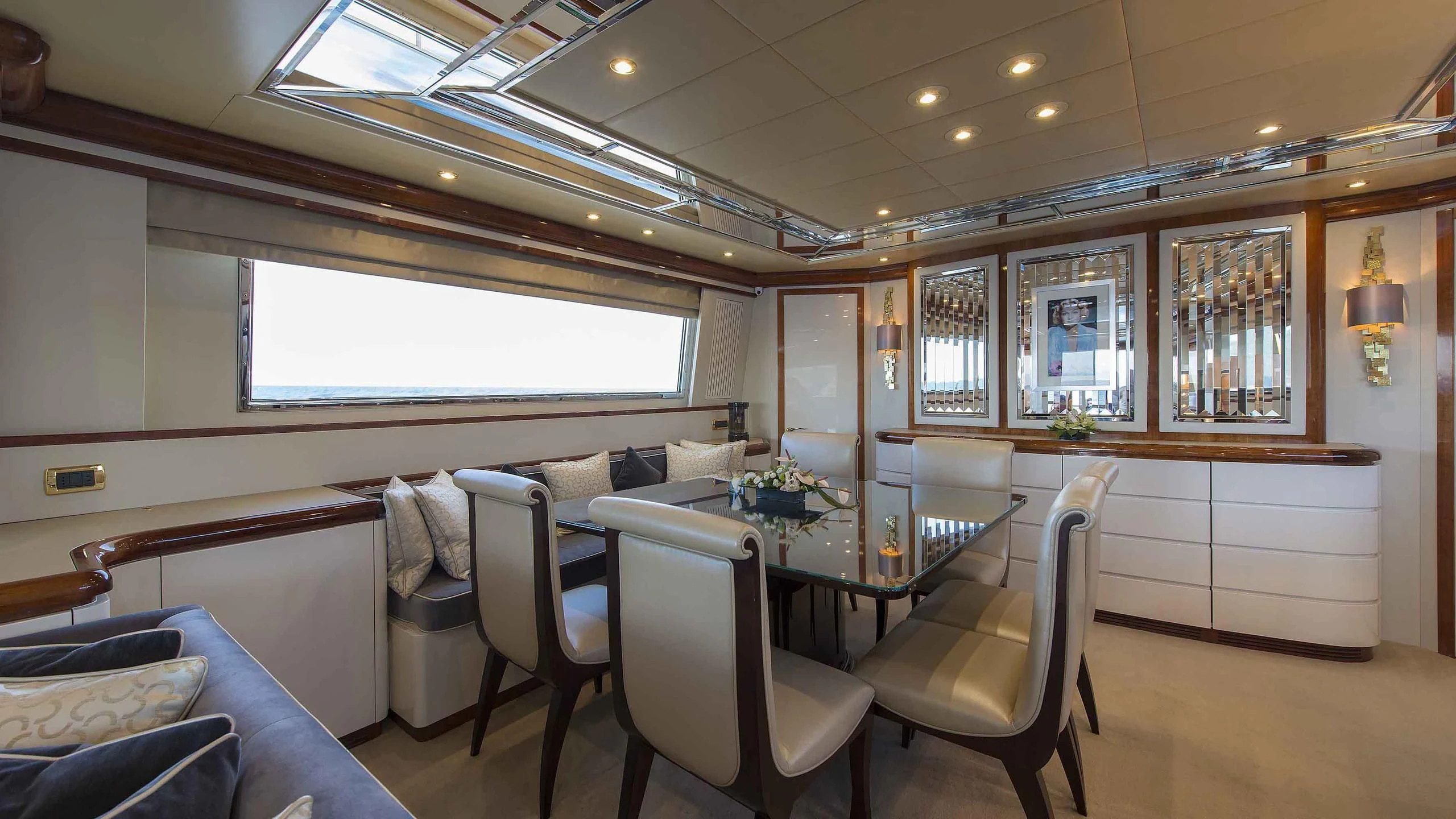 a room with a table chairs and a couch aboard LUMINOUS Yacht for Sale