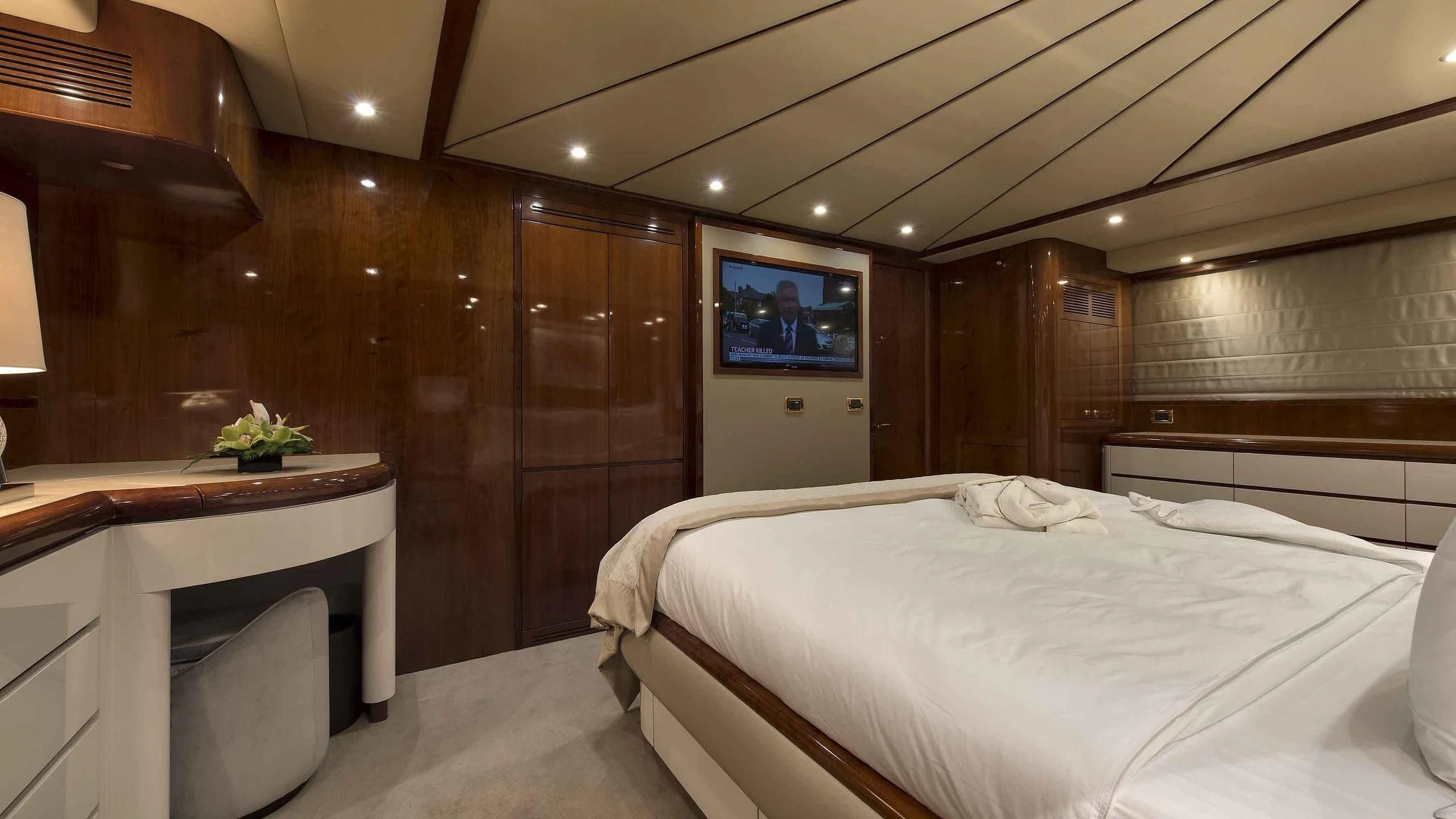 a room with a bed and desk aboard LUMINOUS Yacht for Sale